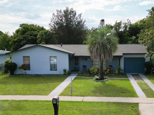 ranch-style house featuring a front yard and a garage