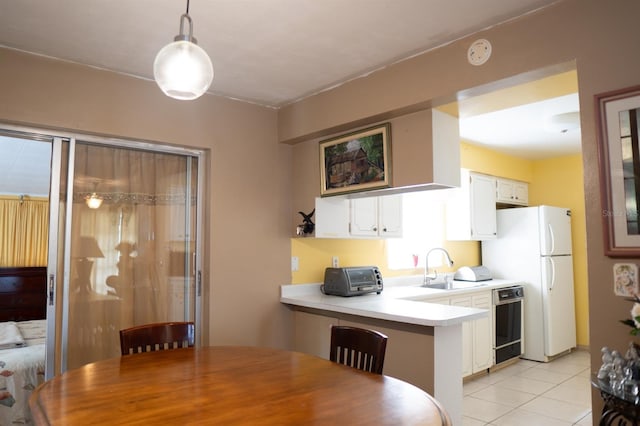 kitchen with pendant lighting, kitchen peninsula, dishwasher, and white cabinets