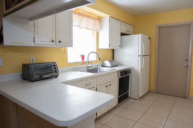 kitchen with dishwasher, white cabinets, sink, and light tile patterned floors