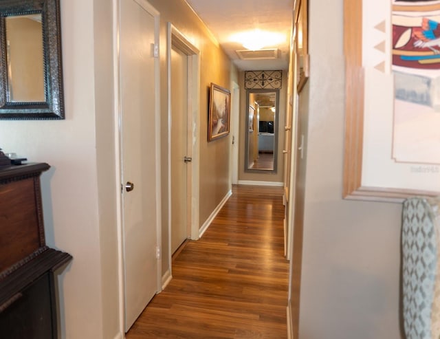 corridor with dark hardwood / wood-style flooring