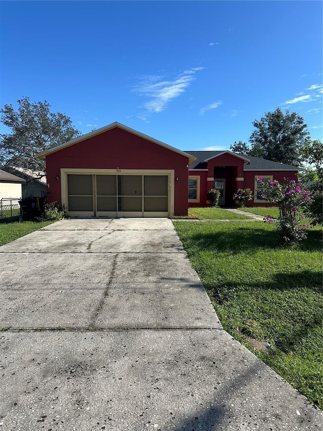 ranch-style house featuring a garage and a front yard