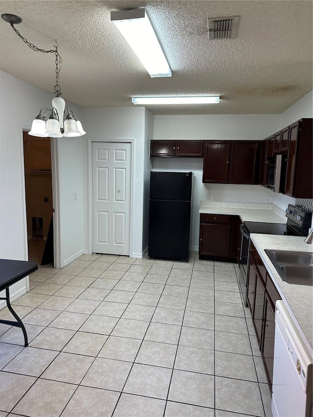 kitchen featuring black fridge, decorative light fixtures, a chandelier, dishwasher, and electric range