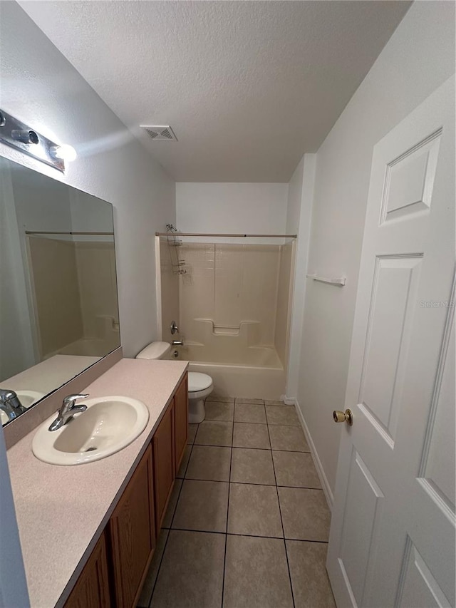 full bathroom featuring vanity, bathing tub / shower combination, tile patterned floors, toilet, and a textured ceiling