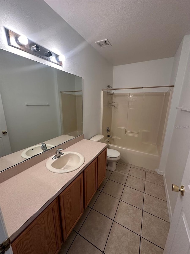 full bathroom with washtub / shower combination, vanity, tile patterned flooring, toilet, and a textured ceiling