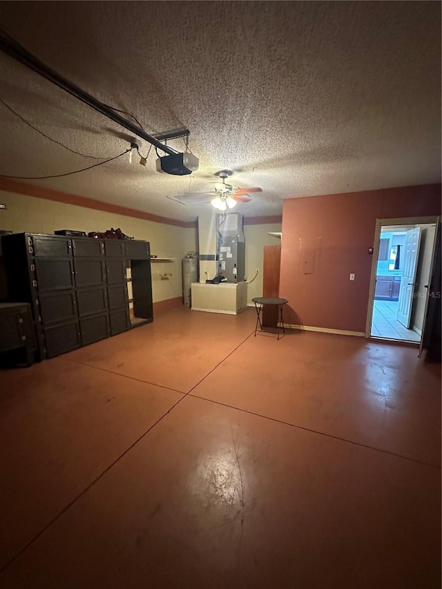 garage featuring ceiling fan, heating unit, a garage door opener, and water heater