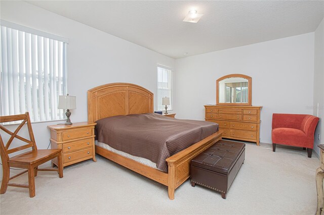 carpeted bedroom with a textured ceiling