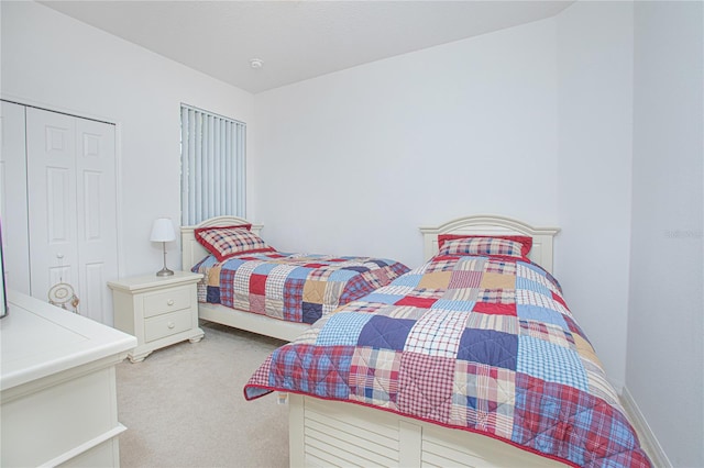 bedroom featuring light carpet and a closet