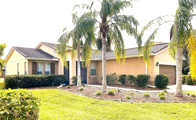 single story home with a front yard and a garage