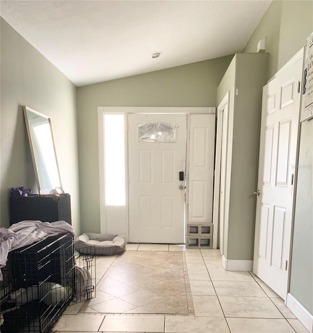 tiled entrance foyer featuring lofted ceiling