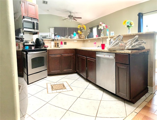 kitchen featuring light tile patterned flooring, ceiling fan, sink, stainless steel appliances, and lofted ceiling