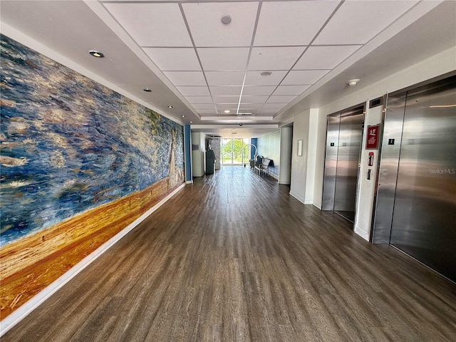 hallway with elevator and dark hardwood / wood-style floors