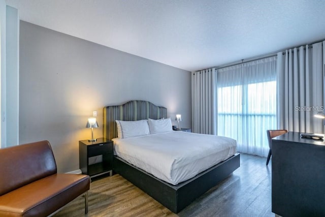 bedroom with dark hardwood / wood-style floors