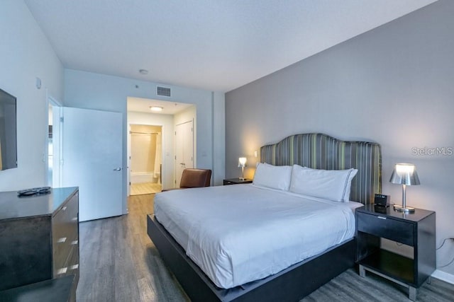 bedroom with dark wood-type flooring