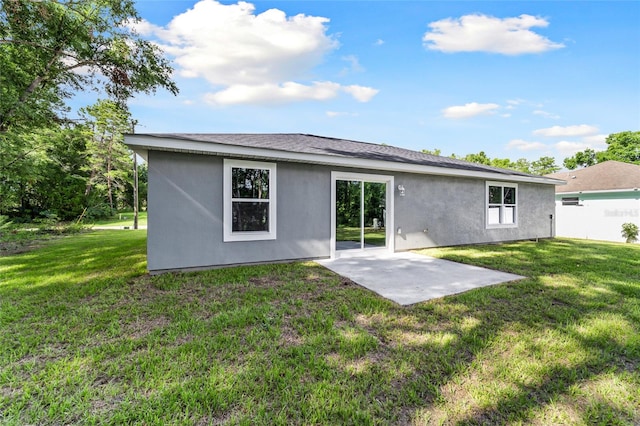 rear view of house with a yard and a patio