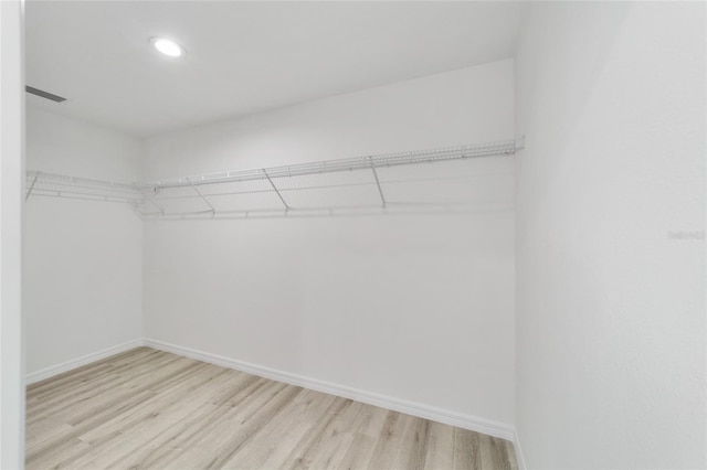 spacious closet with light hardwood / wood-style flooring