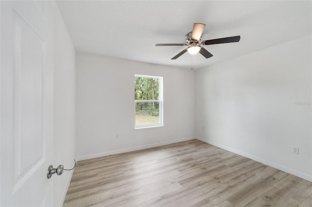 empty room featuring ceiling fan and light hardwood / wood-style floors