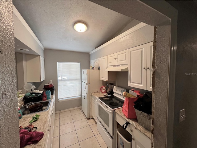 kitchen featuring light tile patterned flooring, white appliances, lofted ceiling, white cabinets, and a textured ceiling