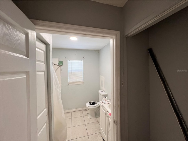 bathroom with tile patterned flooring, vanity, and toilet