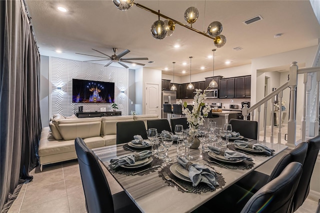 dining space featuring ceiling fan and light tile patterned floors