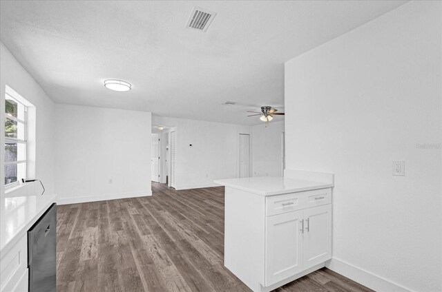 unfurnished living room with ceiling fan, hardwood / wood-style floors, and a textured ceiling