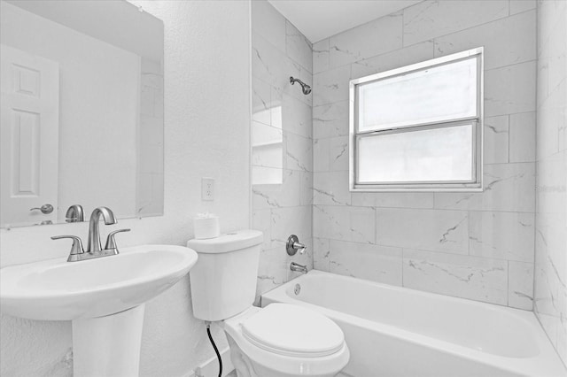 full bathroom featuring sink, toilet, and tiled shower / bath combo