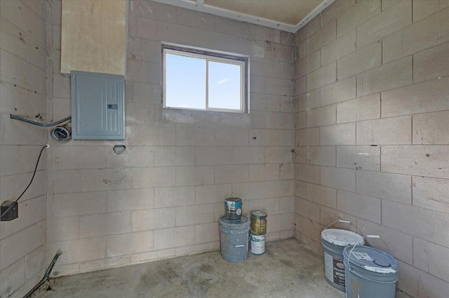 bathroom with electric panel and concrete flooring