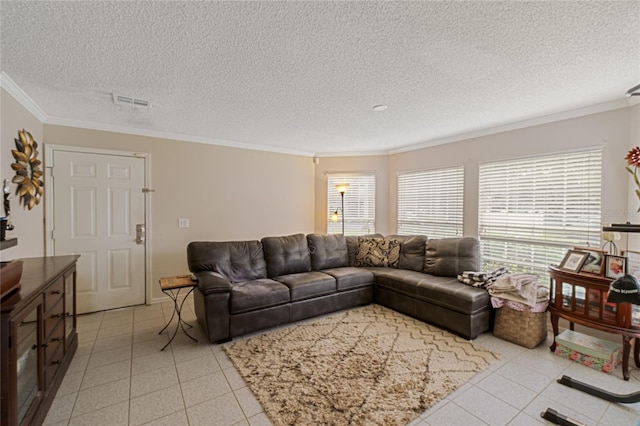 living room with a textured ceiling, ornamental molding, a healthy amount of sunlight, and light tile patterned floors