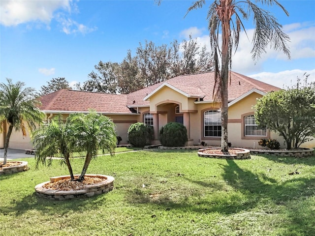 ranch-style home featuring a front yard