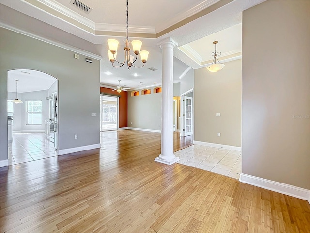 interior space with light hardwood / wood-style floors, decorative columns, and ornamental molding