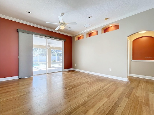 unfurnished room with crown molding, a textured ceiling, and light hardwood / wood-style floors