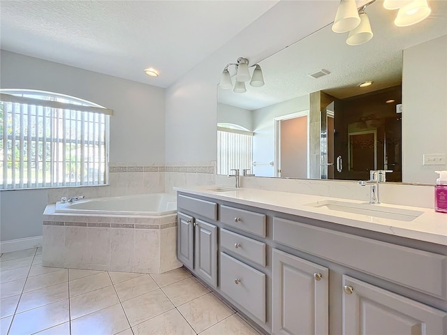 bathroom with vanity, a textured ceiling, separate shower and tub, and tile patterned flooring