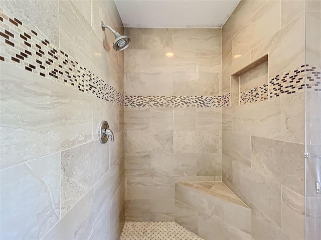 bathroom with tiled shower