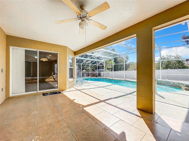 view of pool with a patio area, a lanai, and ceiling fan