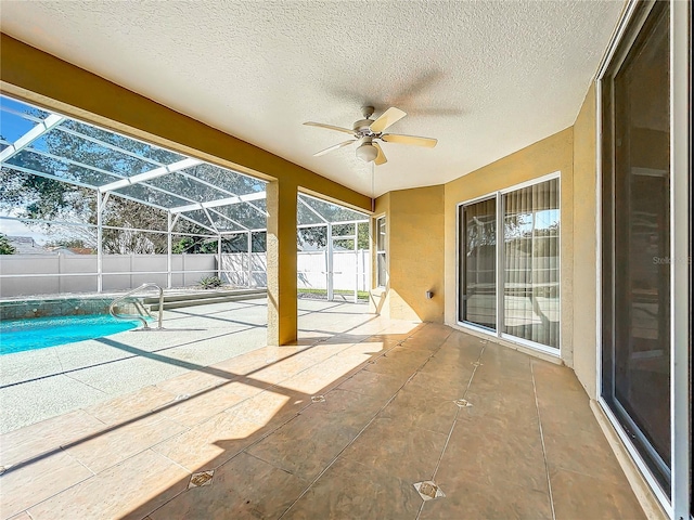 view of patio / terrace featuring a fenced in pool, glass enclosure, and ceiling fan