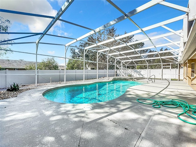 view of swimming pool with a patio and a lanai