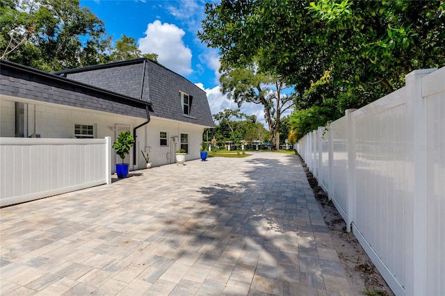 view of side of property with a patio area