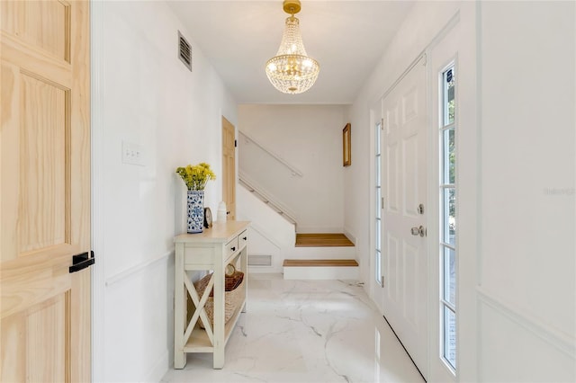 foyer with a chandelier