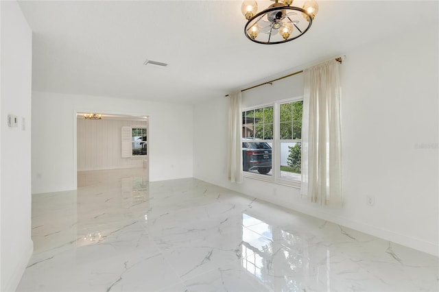 empty room with a notable chandelier