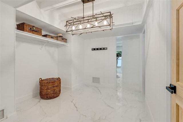 spacious closet featuring beamed ceiling