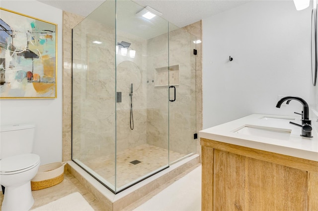 bathroom featuring toilet, tile patterned flooring, vanity, and a shower with door