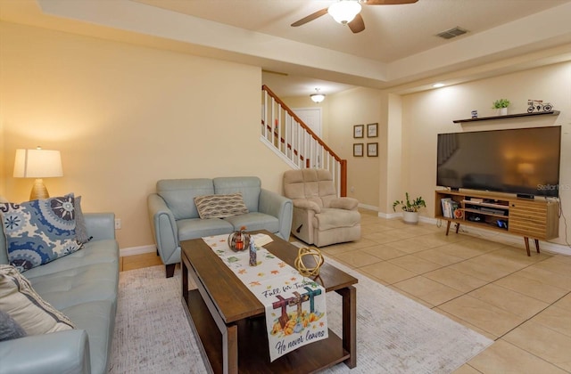 living room featuring ceiling fan and tile patterned flooring