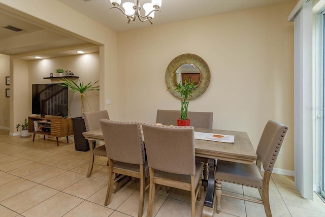 tiled dining area with a chandelier