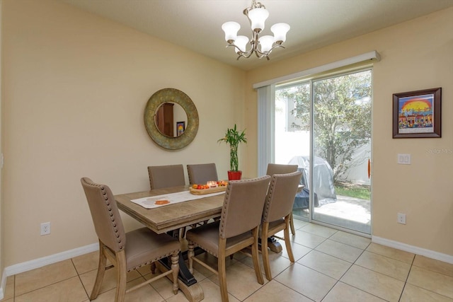 dining room with light tile patterned flooring and an inviting chandelier