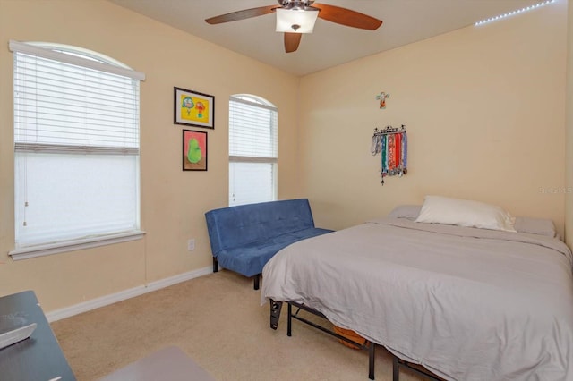 bedroom featuring light colored carpet and ceiling fan