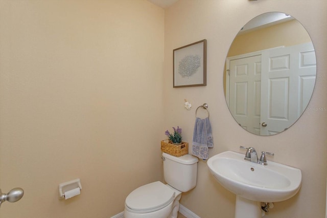 bathroom featuring toilet and sink