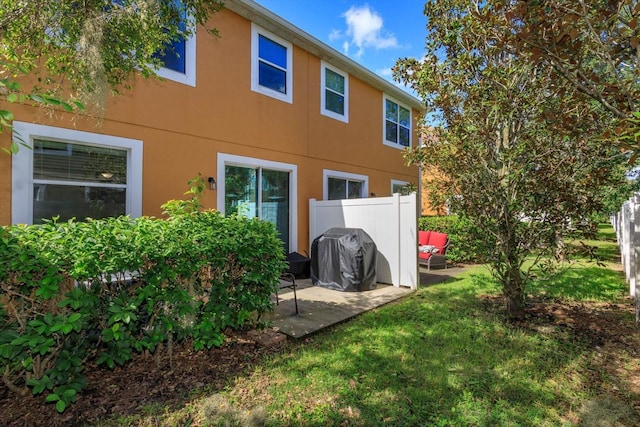 rear view of property with a patio area and a yard