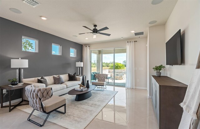 tiled living room featuring ceiling fan