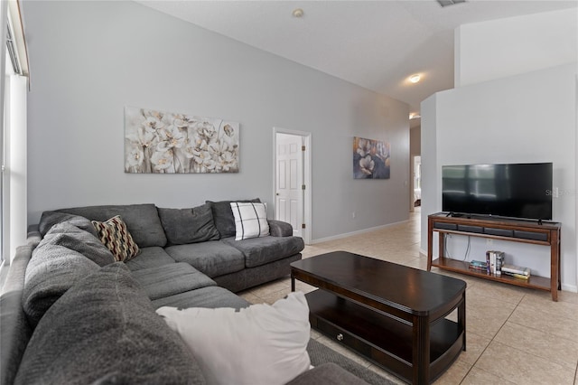 tiled living room featuring high vaulted ceiling