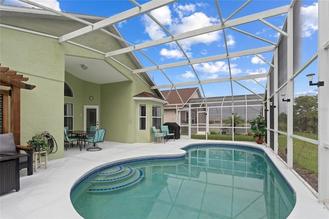 view of swimming pool featuring a patio and a lanai