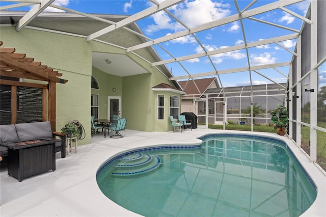 view of swimming pool featuring glass enclosure and a patio area